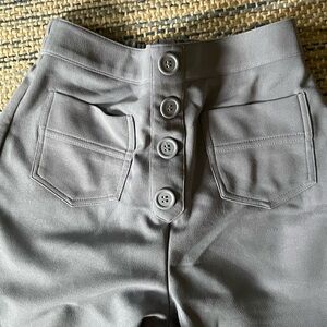 Women’s stretch pants button details.